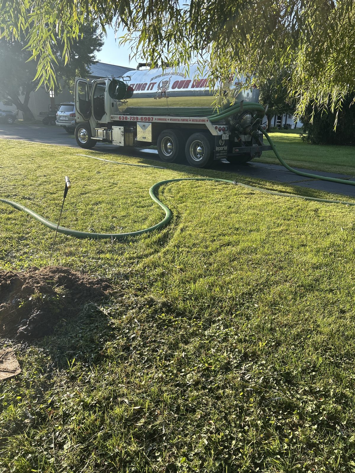Ability Septic truck and hose at golden hour