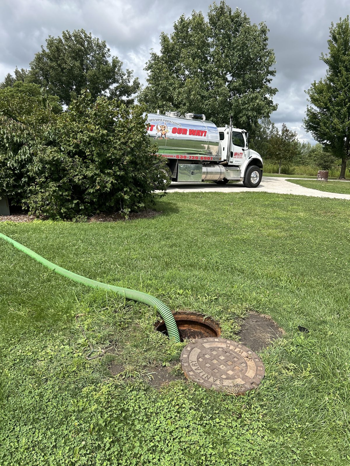 Ability Septic technician pumping a residential septic tank