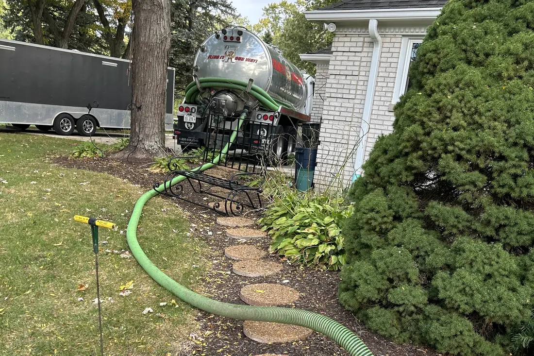 Hose run along a stepping-stone path through landscaping